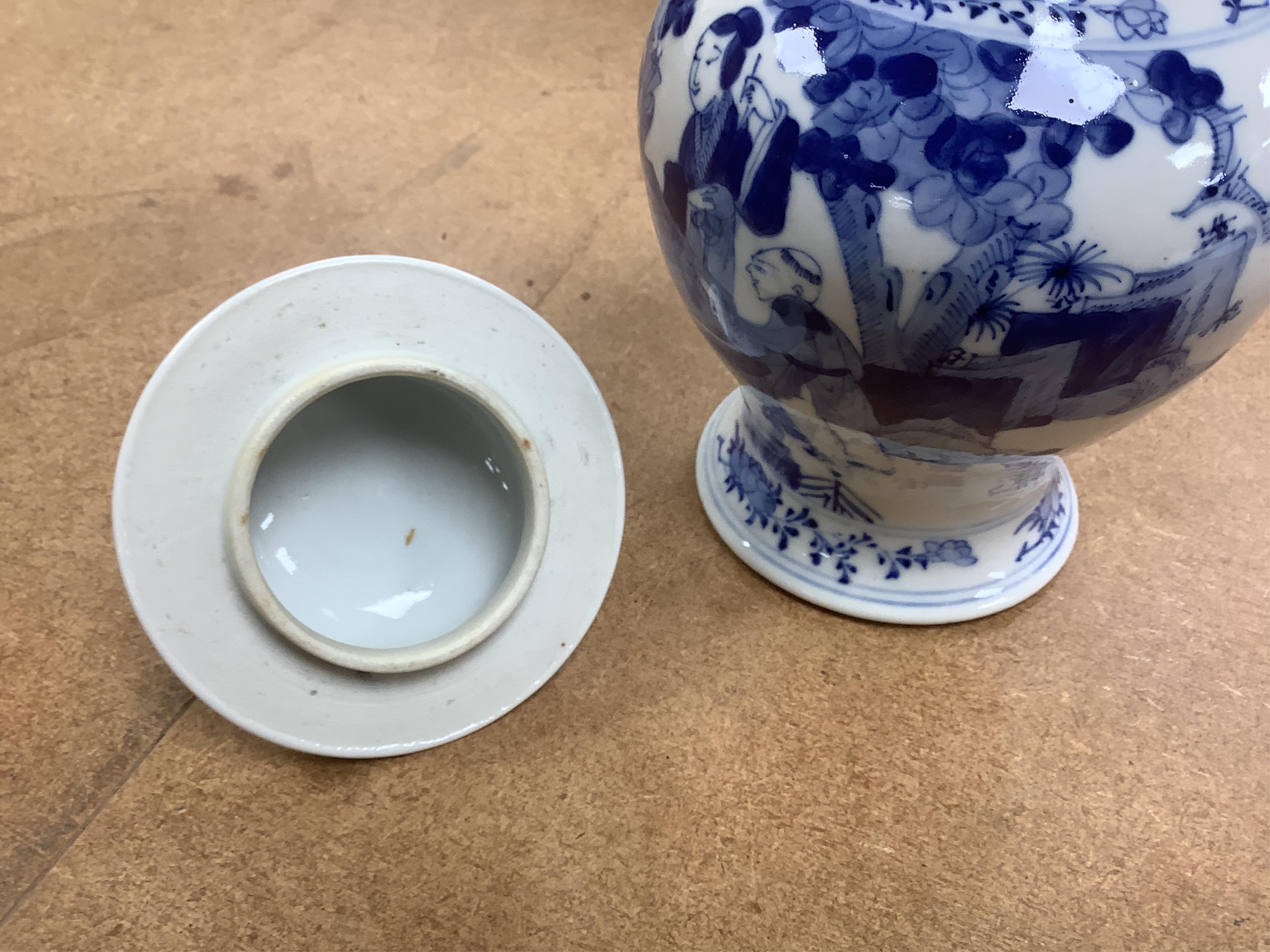 An early 20th century Chinese blue and white porcelain vase and cover decorated with figures in a landscape and a Japanese circular bowl, tallest 23cm. Condition - good